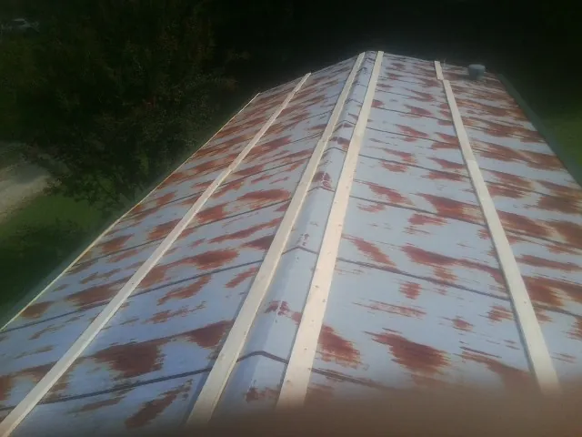 Rusted metal roof panels with new wood purlins before replacement — Storm Damage Roof Repair in Tracy by Roofing Brothers